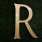 signage showing the letter R over greenery