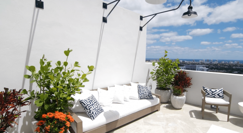 bright outdoor patio area with foliage and modern seating