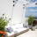 bright outdoor patio area with foliage and modern seating