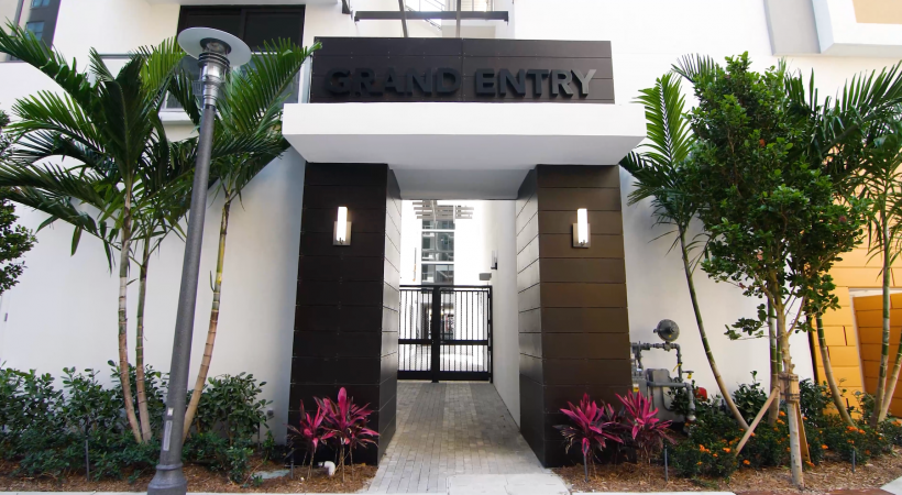 a property entrance showing nearby landscaping