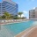 Rooftop swimming pool surrounded by lounge chairs at The Registry Las Olas