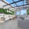 rooftop lounge with open ceiling and stringed lighting along steel beams