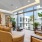 Sitting area in front of floor-to-ceiling windows in sky lounge at The Registry Las Olas